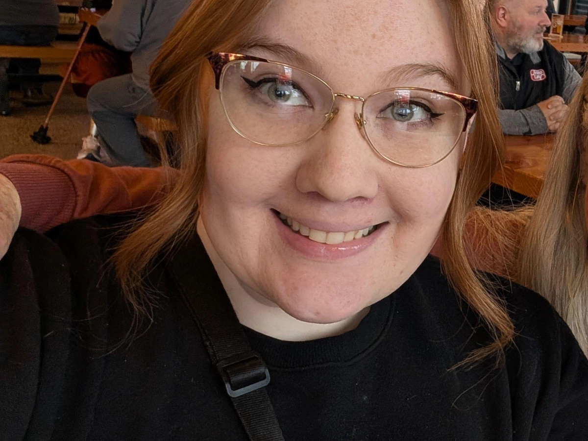 Gwen Smith, Board Member, smiling in the middle of the picture